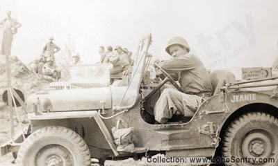 [Bill Mauldin (Willie and Joe Cartoonist) in His Jeep Jeanie]