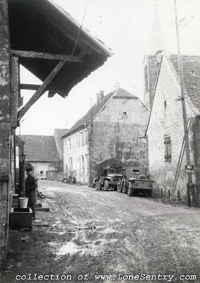 [Truck and jeep in a French town]